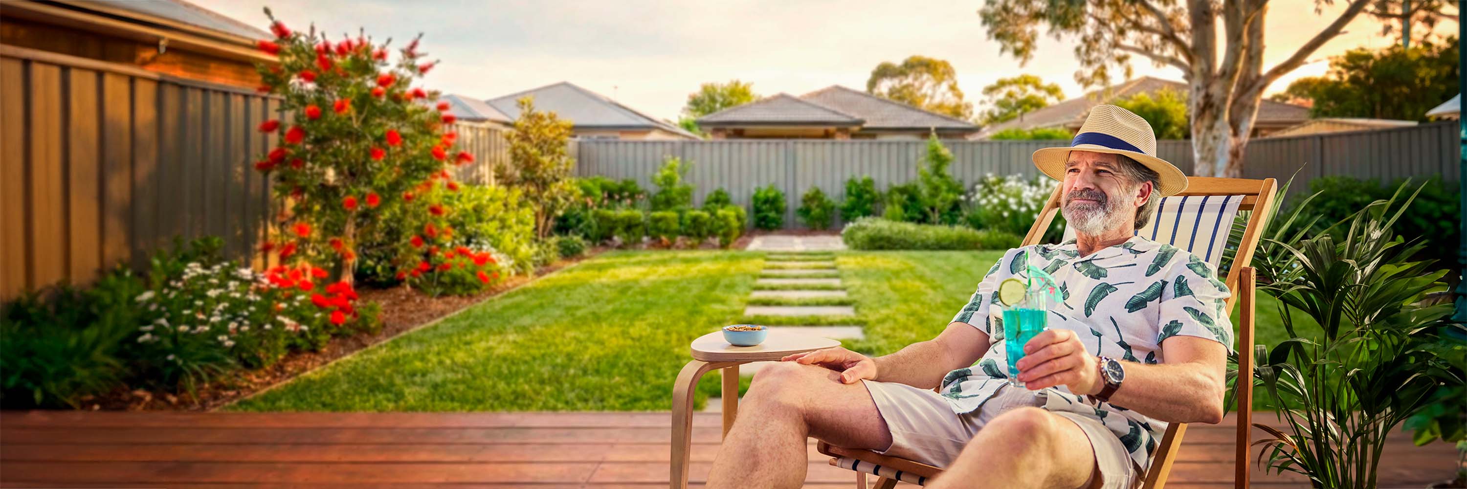 Man relaxing in backyard, on deck in a deck chair