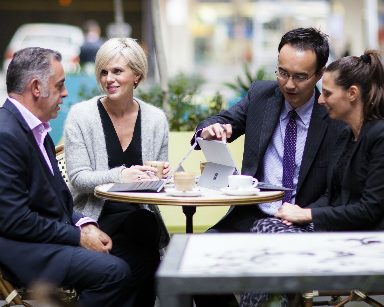 Colleagues in a meeting outside using tablet devices