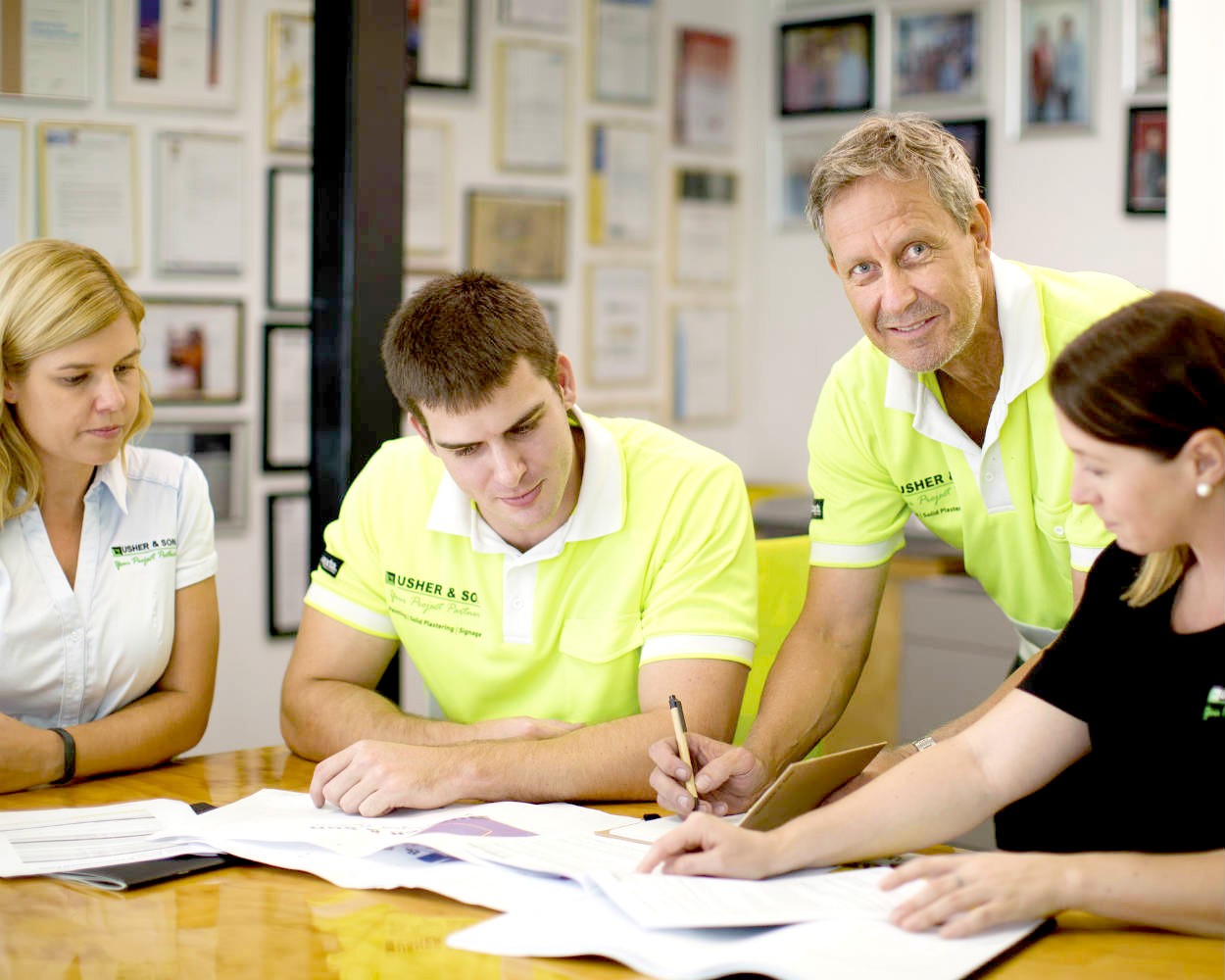 A team of colleagues in a meeting looking at documents 