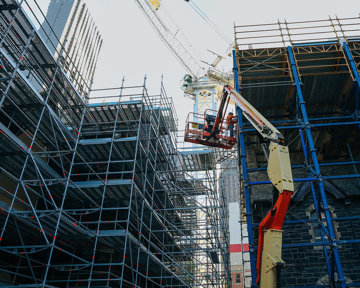 Looking up to a crane and a construction site