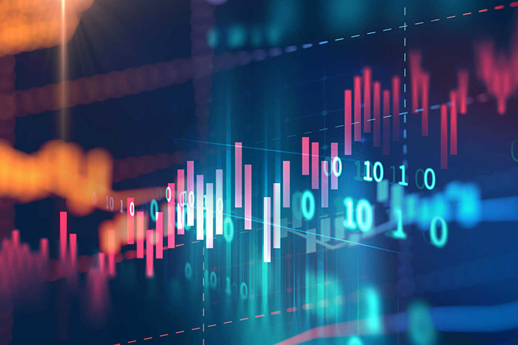 Wind turbines in green trees by the coast