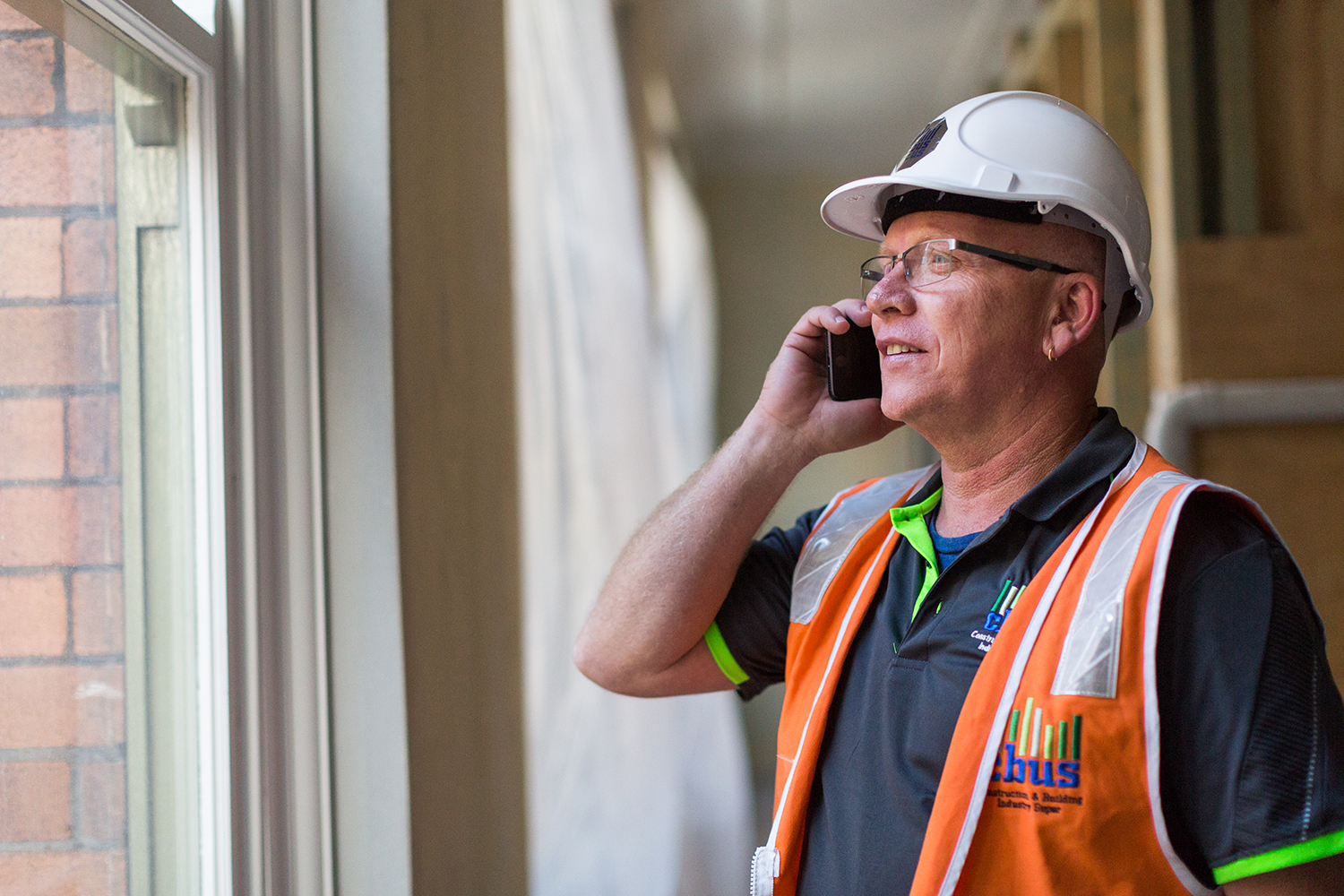 male tradie on mobile phone