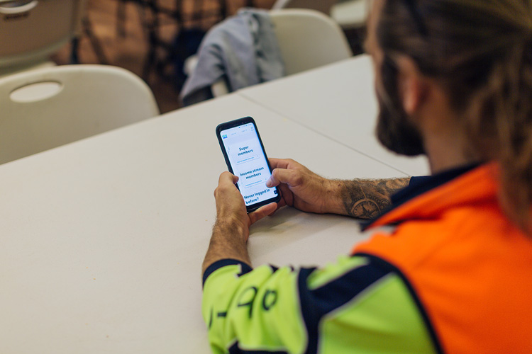 Male tradie looking at phone