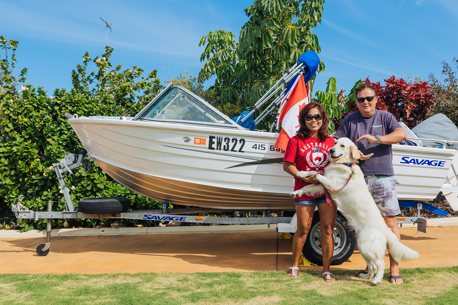 Retired couple in front of boat