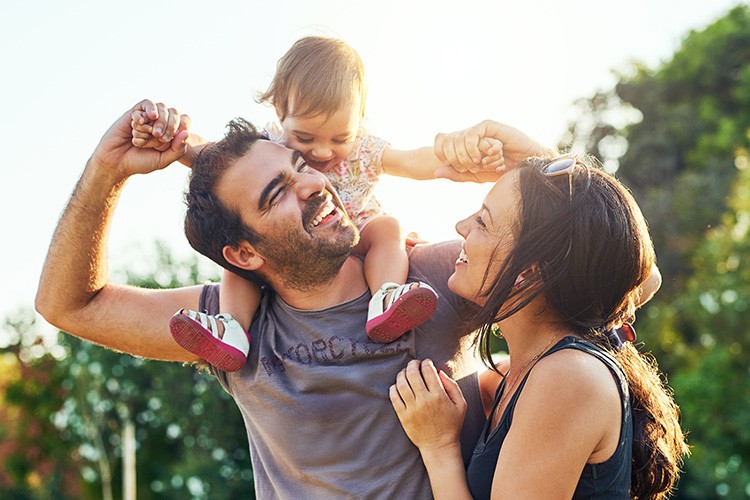 Young family, man with small child on shoulders