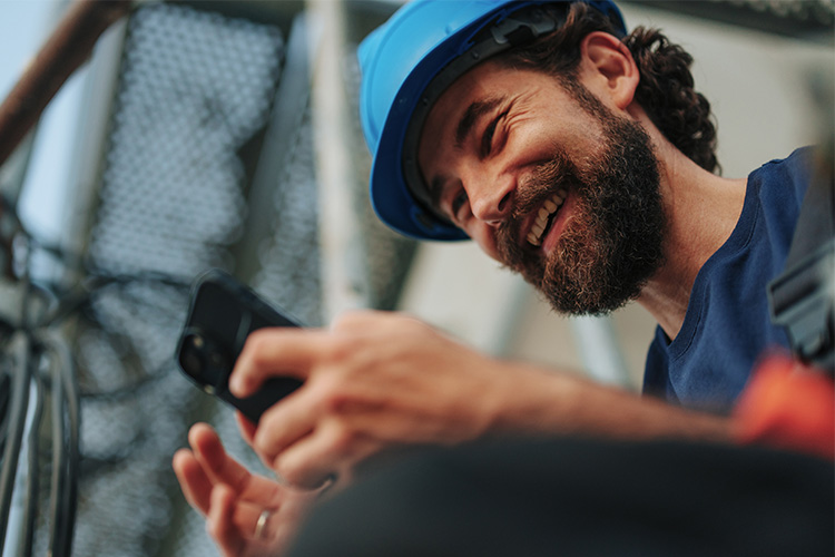 Construction worker looking at smartphone