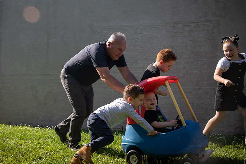 retirement member playing with grandchildren