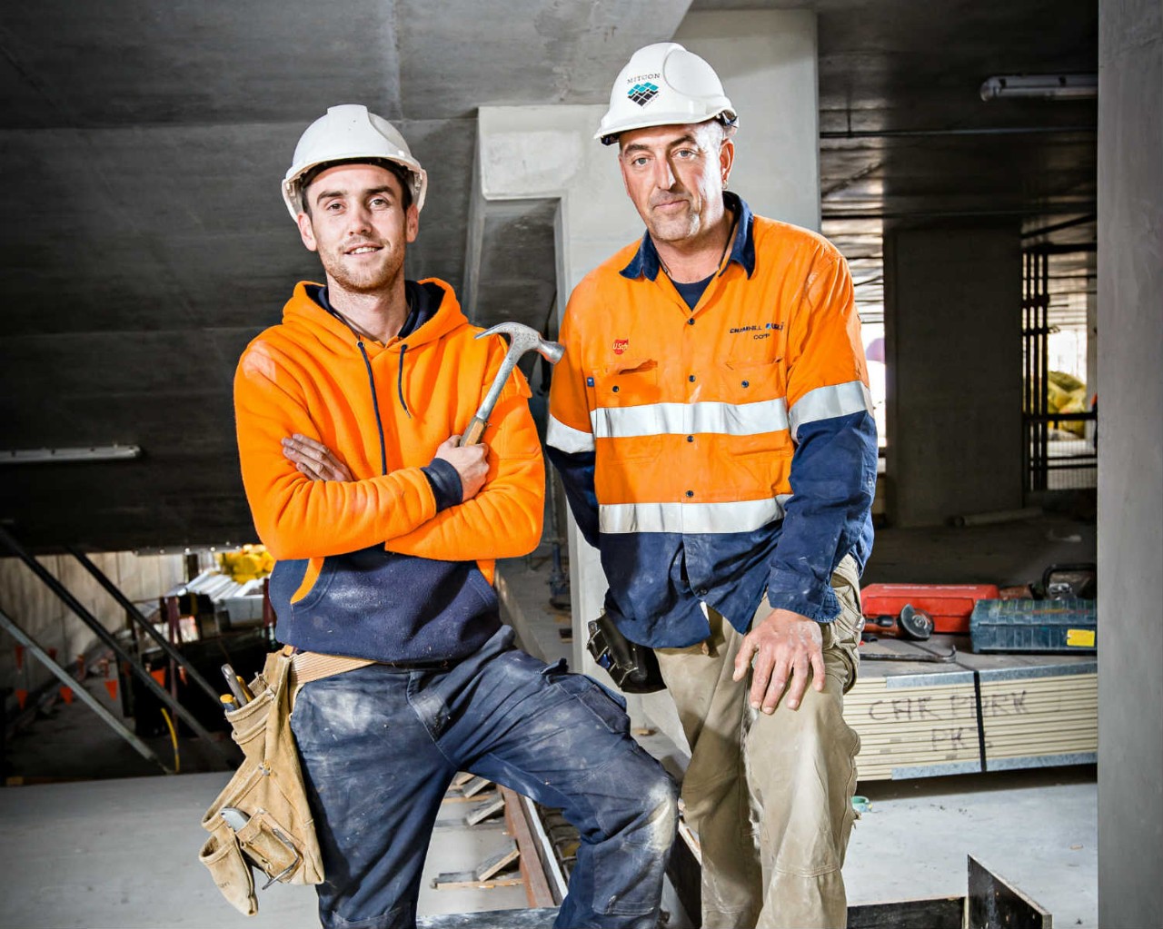 Two construction workers with a hammer