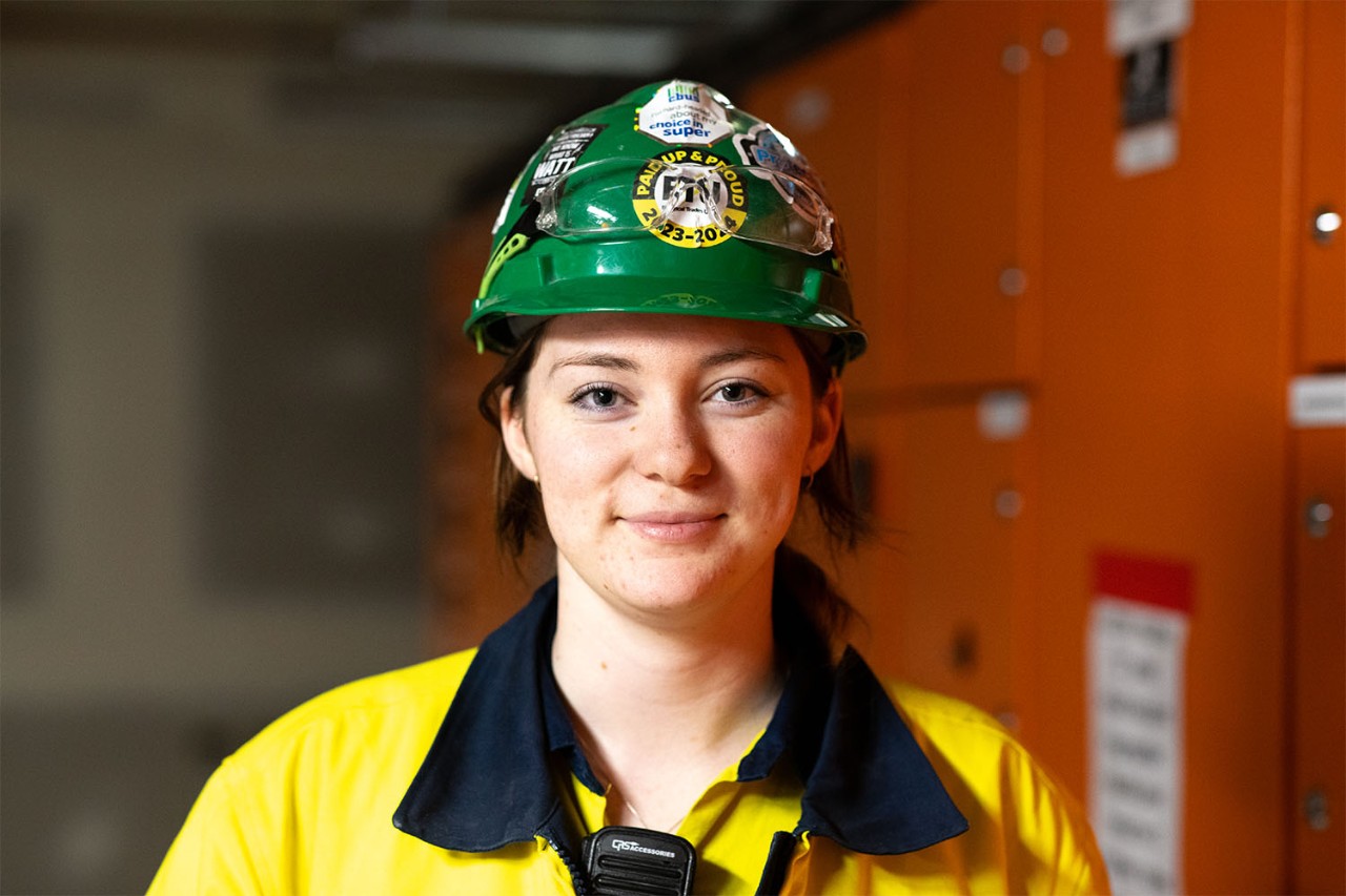 Male tradies with their hands in the industry super symbol